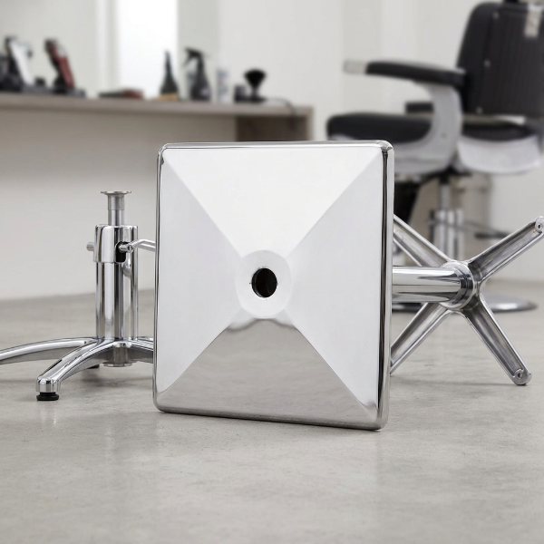 Chrome Barber Chair Base Plate connecting to a hydraulic salon chair base assembly.